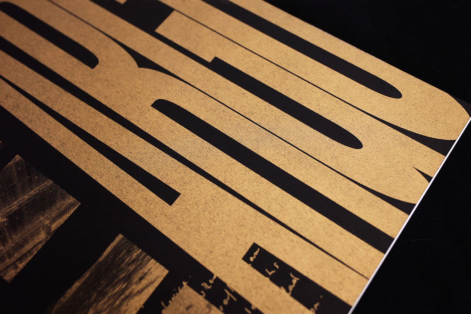 ARGO cover type in gold Riso, seen at a raking angle on black