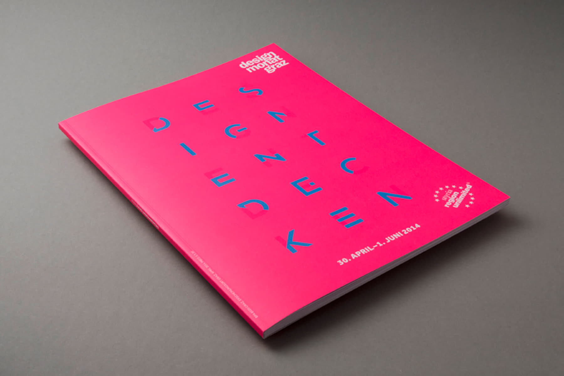 Pink magazine cover with scattered letters