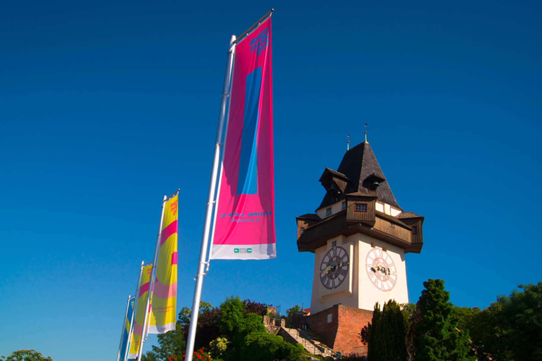 Festival flags in front of the Graz clock tower