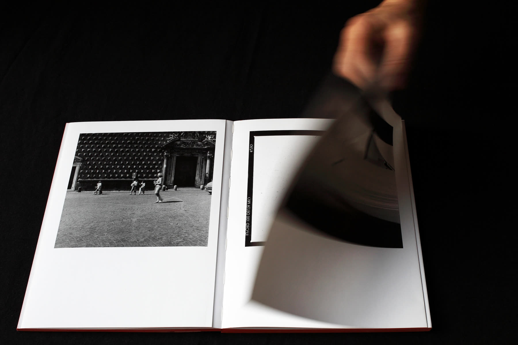 A hand turning a page of the catalogue