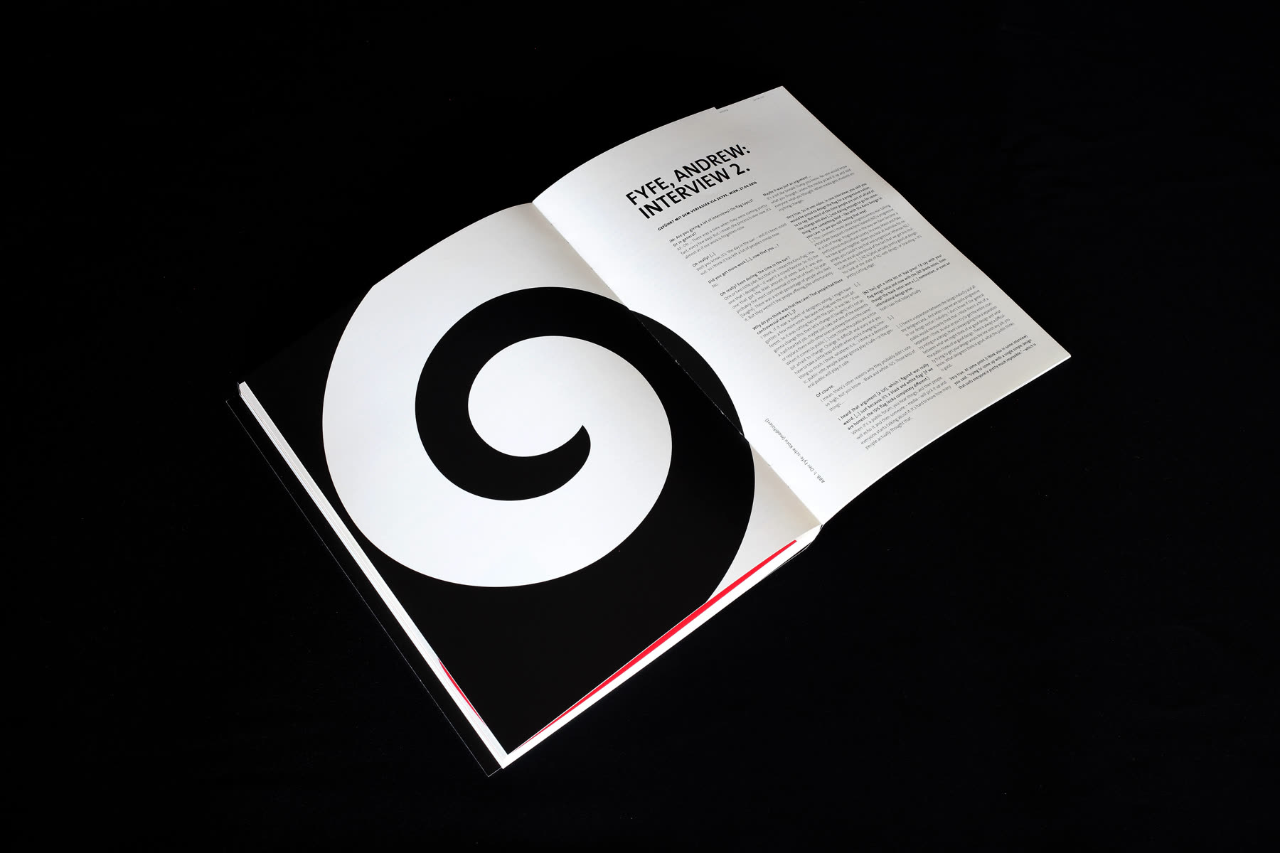 Spread with a large black spiral beside an interview