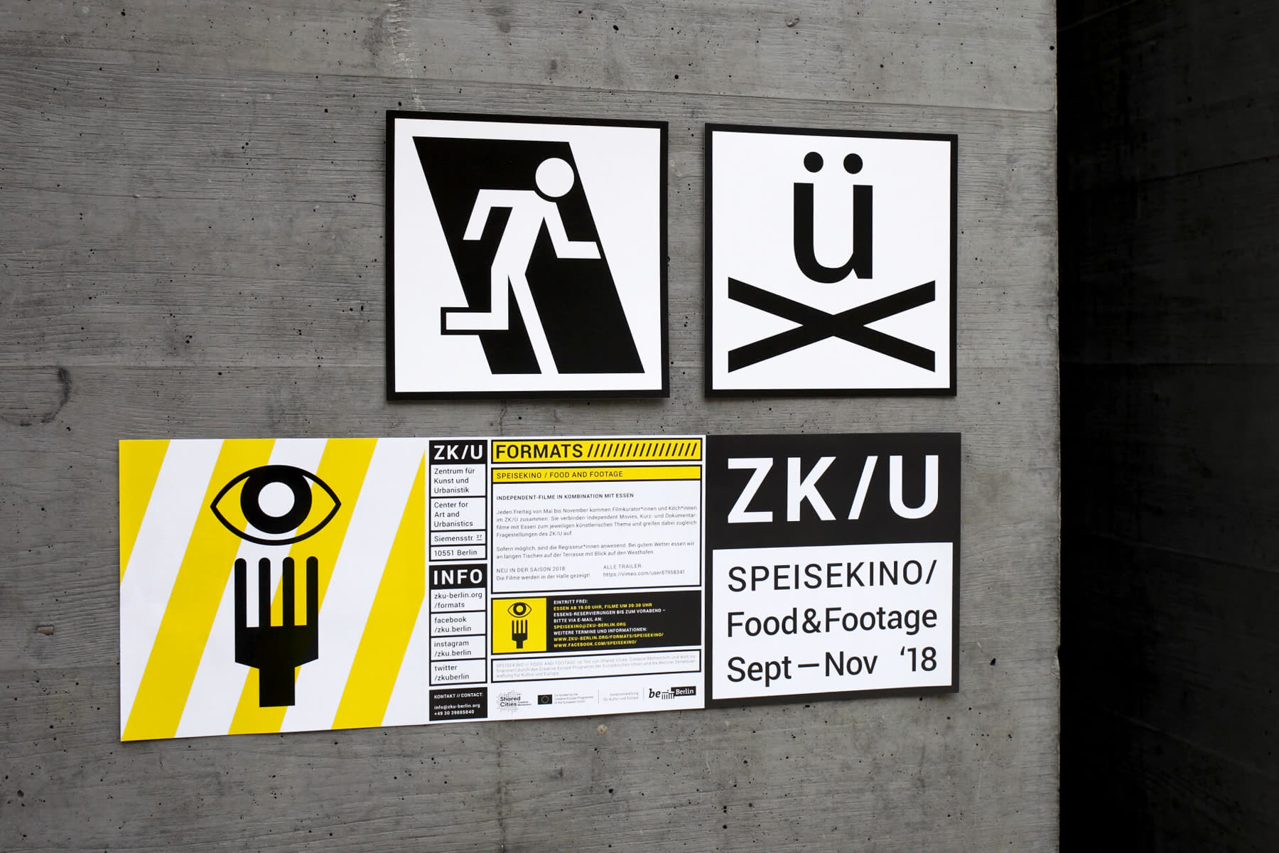 Posters and pictograms on a concrete wall
