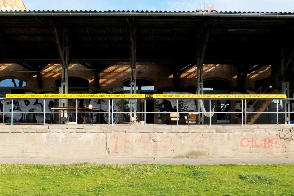 The former railway depot with a yellow band along the roof