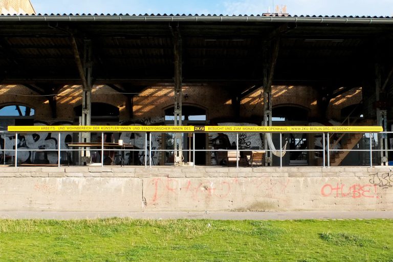 The former railway depot with a yellow band along the roof