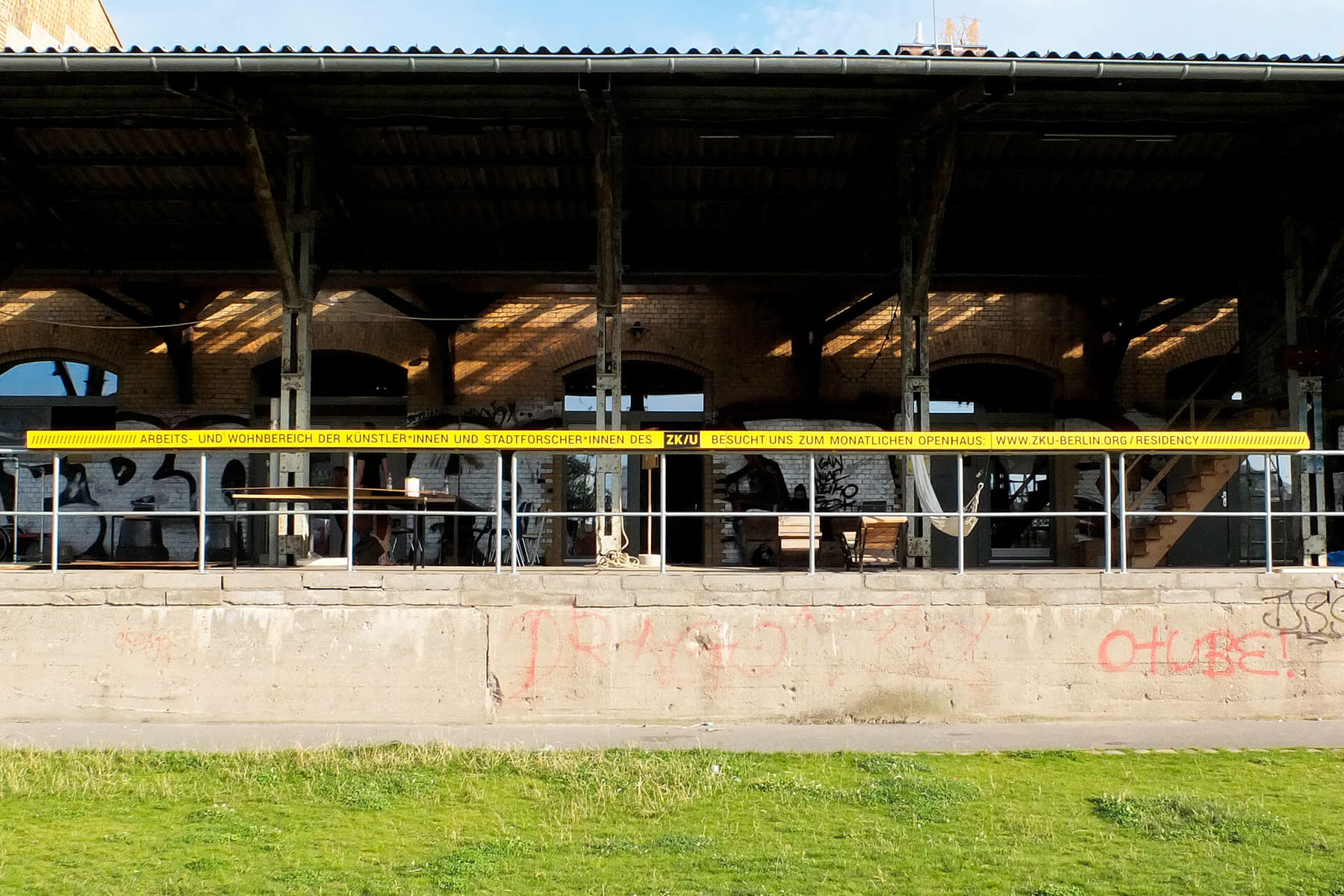 The former railway depot with a yellow band along the roof